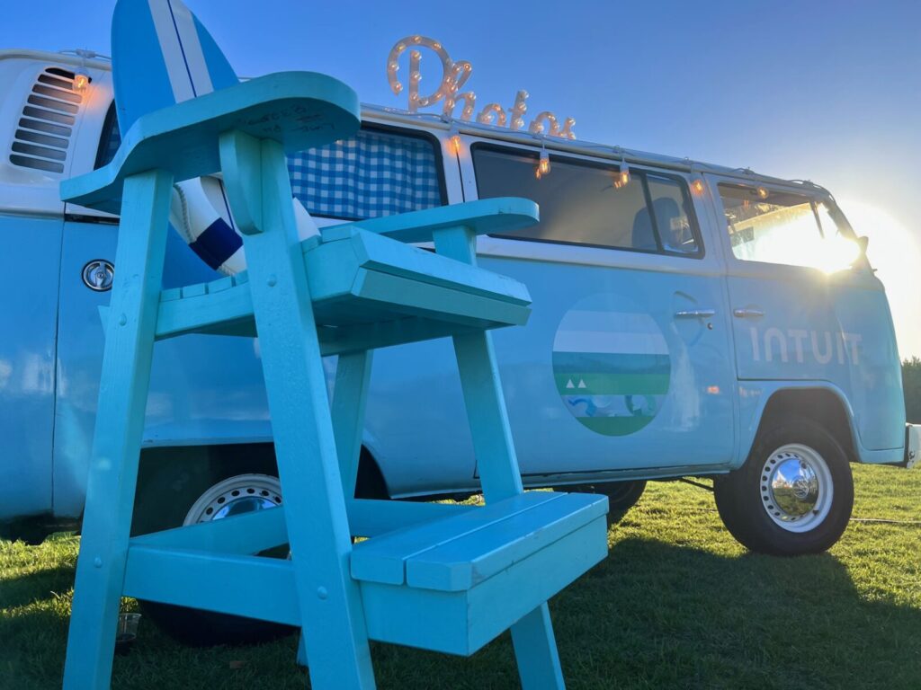 Callie, Coachella Party VW Photo Booth Bus is seen at Terranea resort in Los Angeles during an event for Intuit. The bus is branded with a magnet to Intuit logo. There is a Beach chair in front of the bus. The theme was classy nautical event